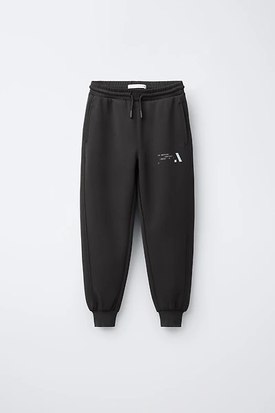 PANTALON JOGGER SPORTIF INSCRIPTION RÉFLÉCHISSANTE