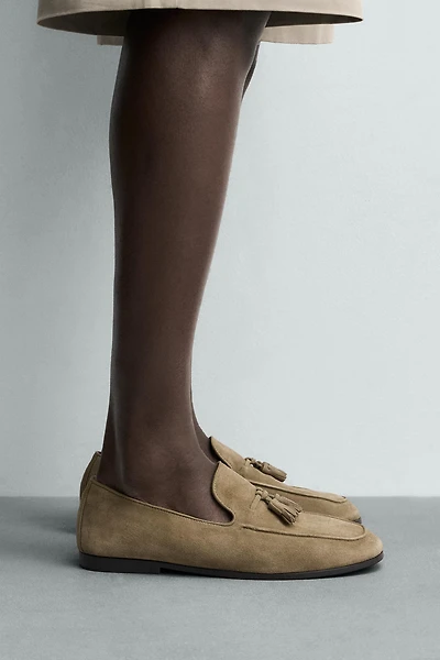 MOCASSINS EN CUIR À POMPONS