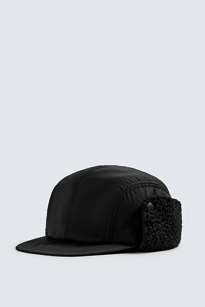TECHNICAL CAP WITH SHEARLING EAR FLAPS
