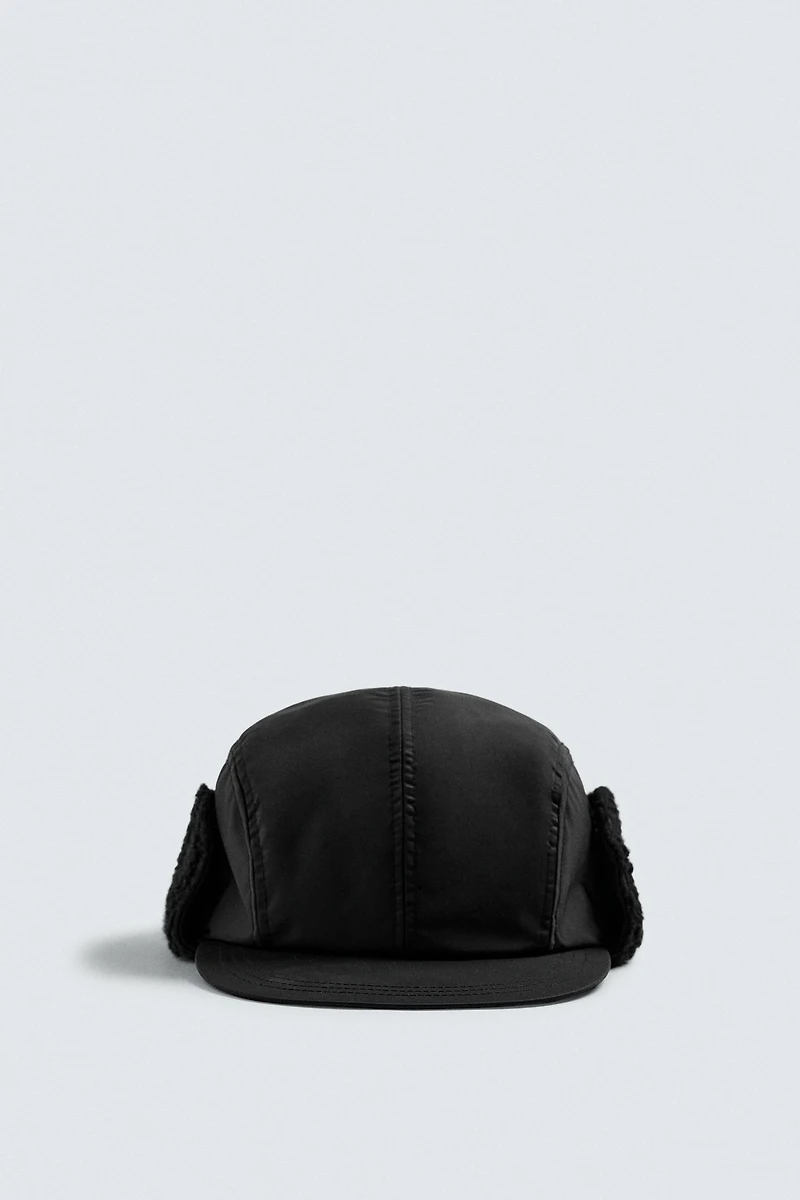 TECHNICAL CAP WITH SHEARLING EAR FLAPS