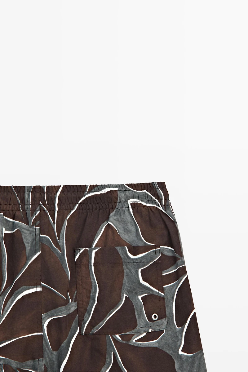 Tropical print swimming trunks