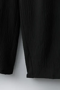 PANTALON TEXTURÉ JAMBES LARGES JUPE