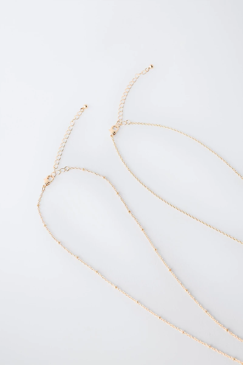 TWO-PACK OF DOLPHIN AND HIBISCUS PENDANT NECKLACES