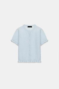 VESTE EN MAILLE STRUCTURÉE À VOLANTS