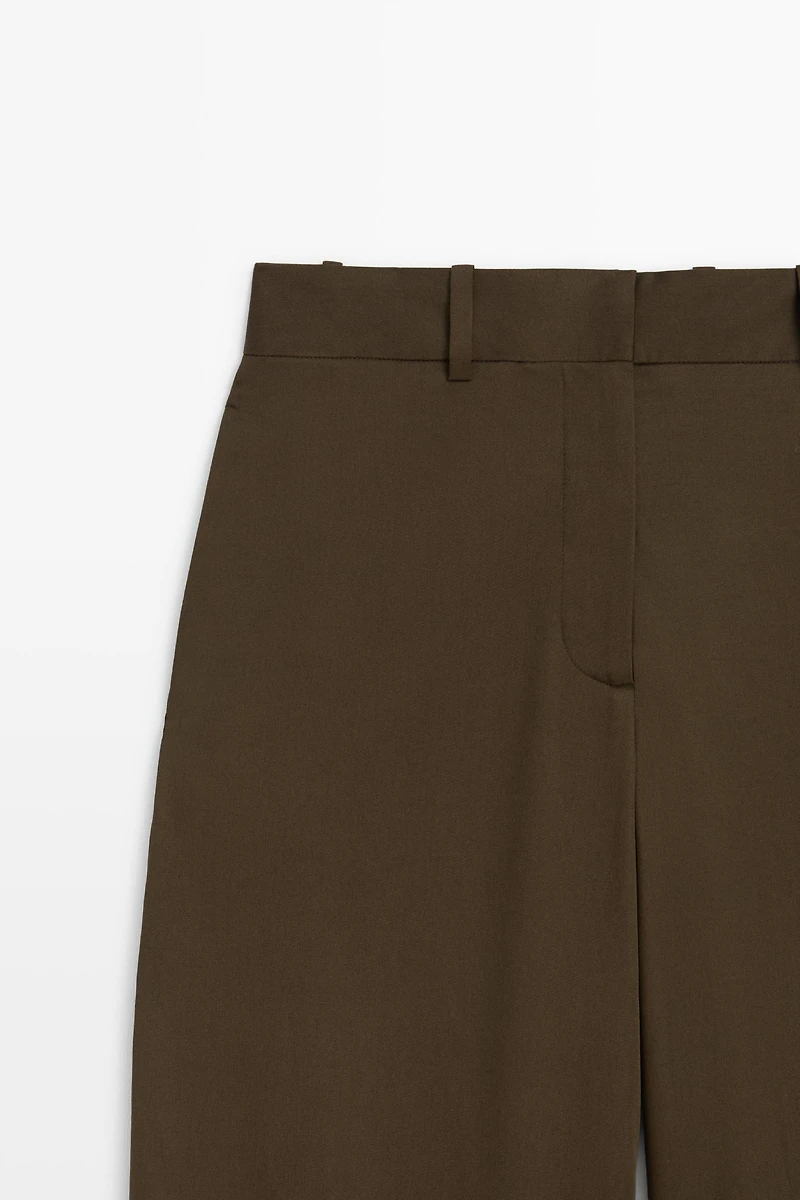Pants with buttoned hem detail
