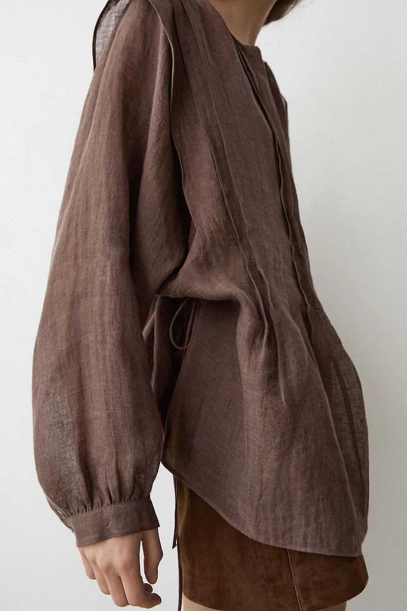 Flowing oversize linen blouse with ruffles
