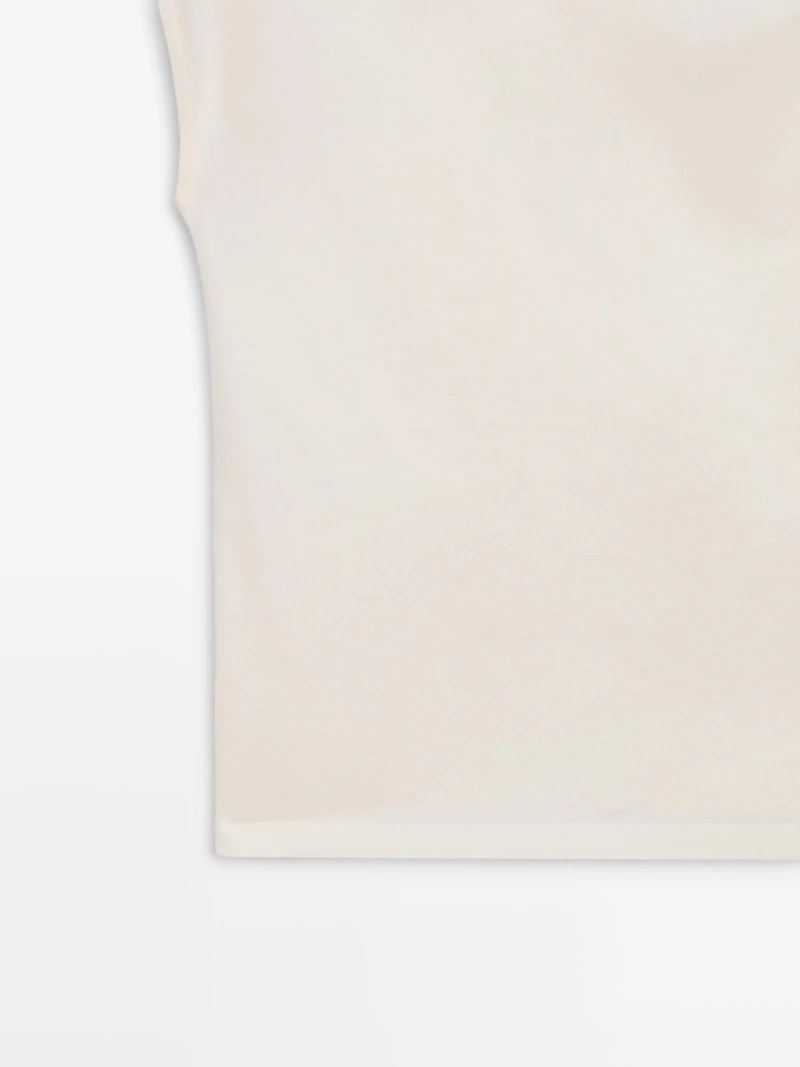 Asymmetric top with shoulder appliqué