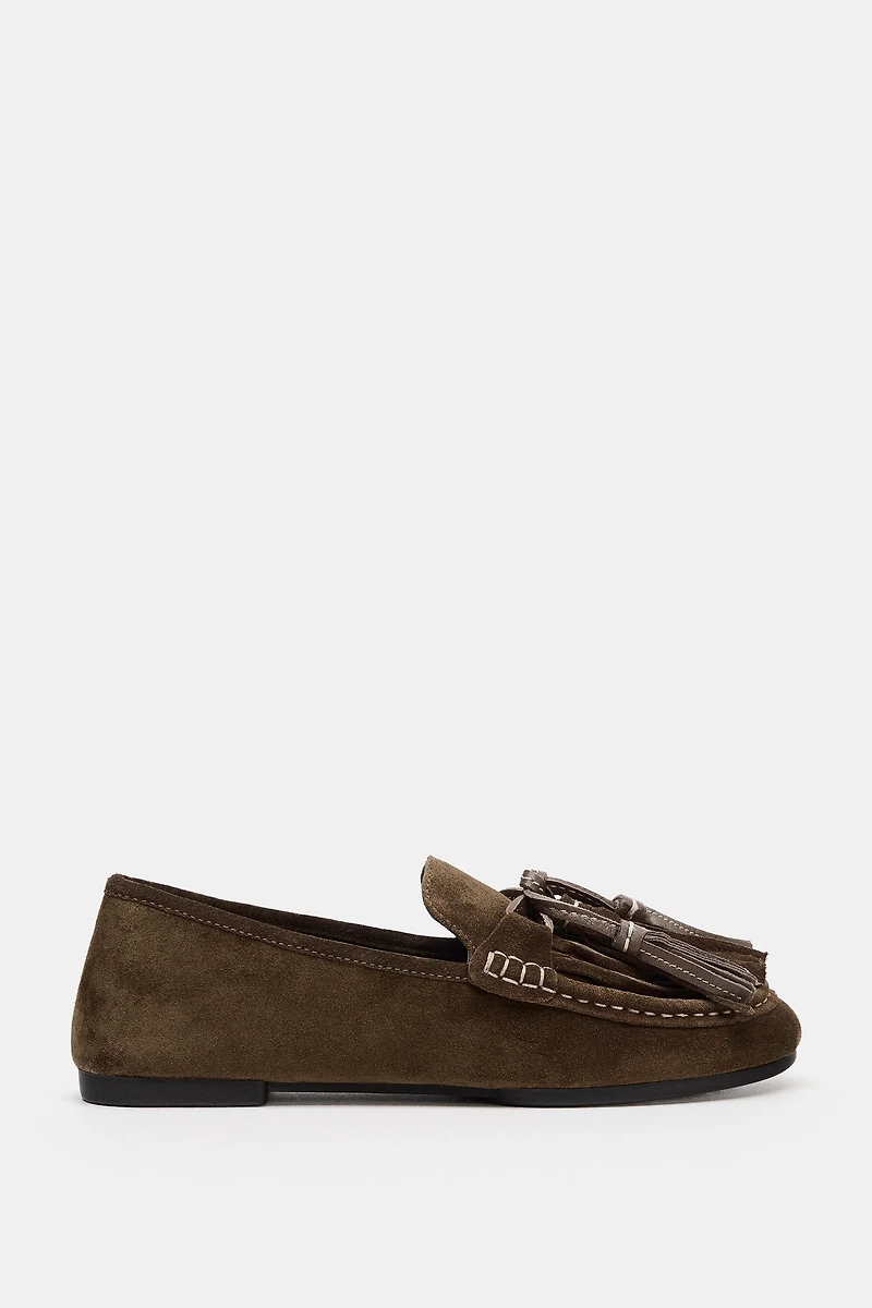 MOCASSINS EN CUIR À POMPONS