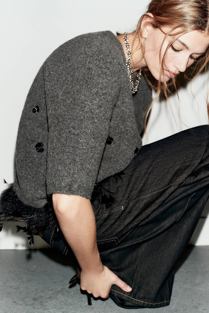 WOOL SWEATER WITH SEQUINS AND FEATHERS