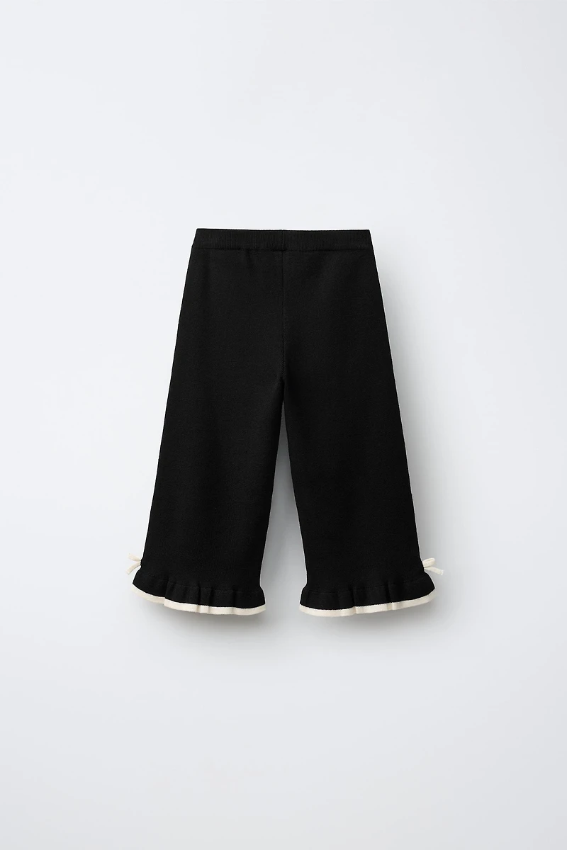 FLARED KNIT PANTS WITH BOWS AND RUFFLE