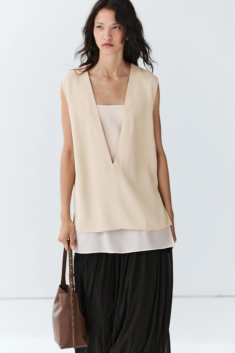 Flowing double-layer top with contrast detail