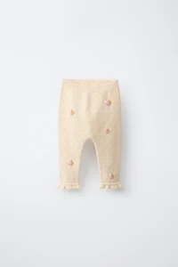 PANTALON AJOURÉ ET POMPONS