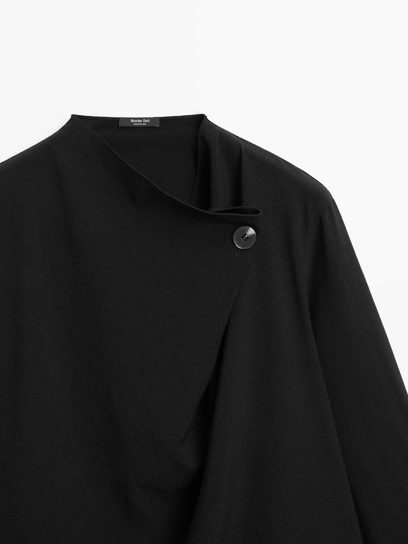 Blouse with crossover detail and button