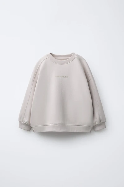 RAISED TEXT SWEATSHIRT