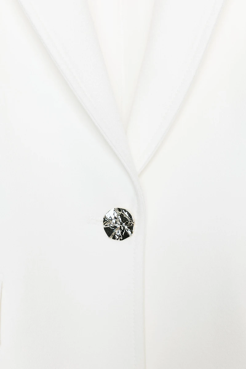 VESTE AJUSTÉE ÉPAULES MARQUÉES