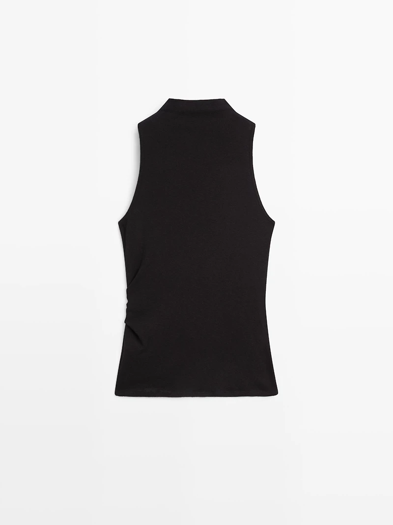 Funnel neck top with brooch detail