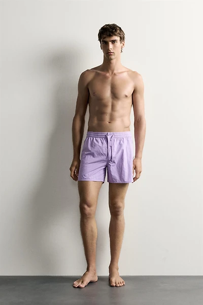 MID-LENGTH SWIMSUIT WITH VENTS