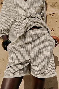 DISTRESSED PLAID SHORTS
