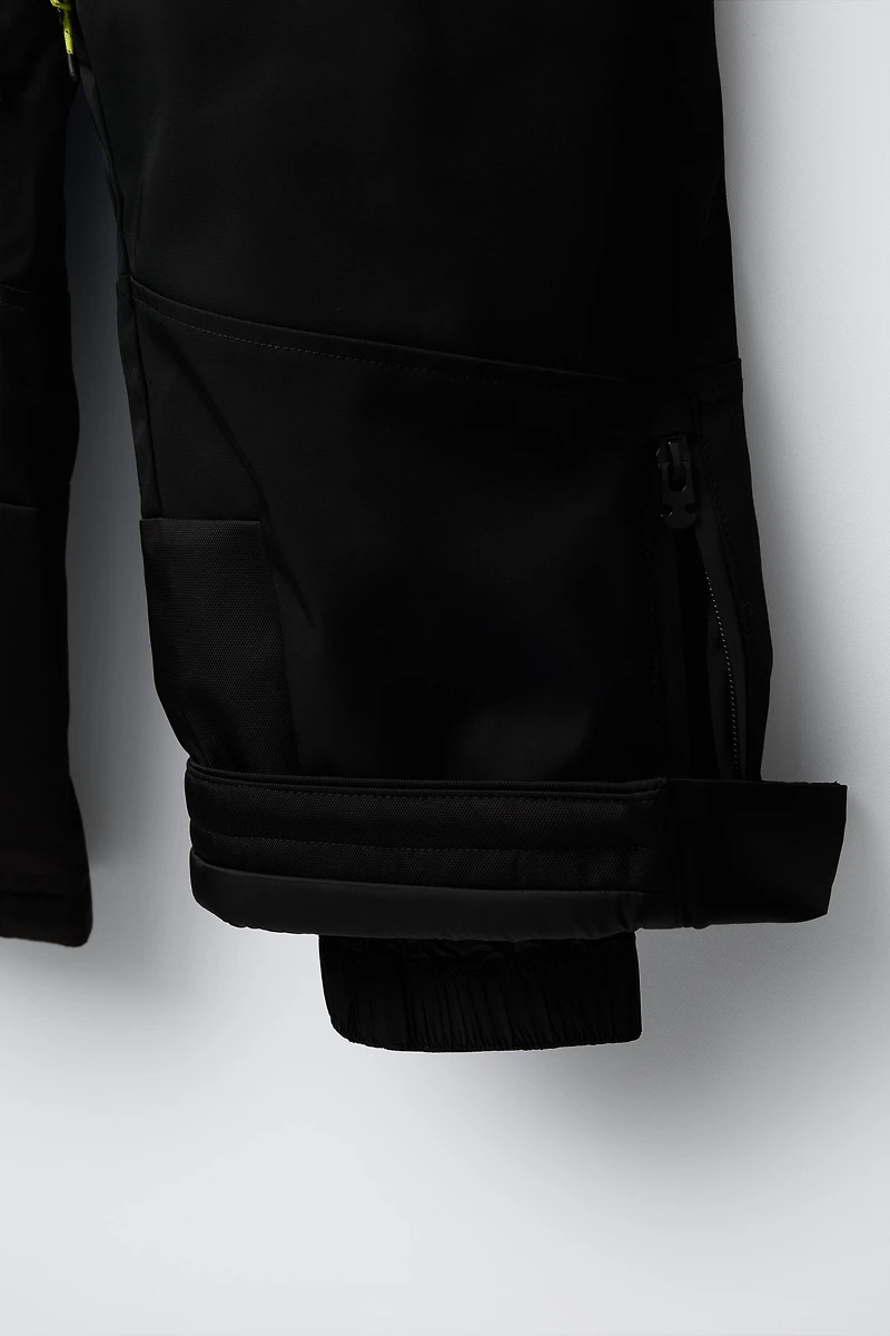 WATER RESISTANT AND WINDPROOF STRAP PANTS RECCO® SYSTEM SKI COLLECTION