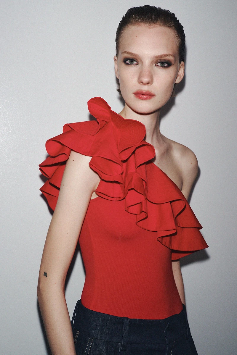 ASYMMETRIC BODYSUIT WITH CONTRASTING RUFFLE