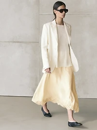 Asymmetric skirt with lace-trimmed detail