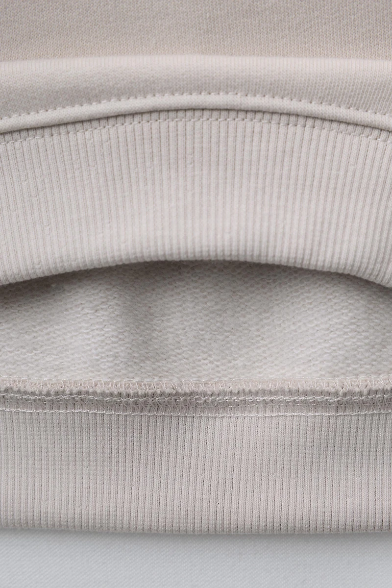 RAISED TEXT SWEATSHIRT