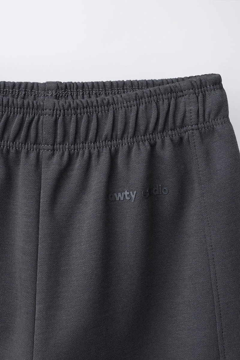 WIDE LEG INTERLOCK RAISED TEXT PANTS