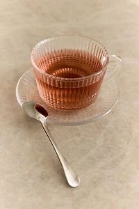 RAISED GLASS TEACUP WITH GEOMETRIC DESIGN