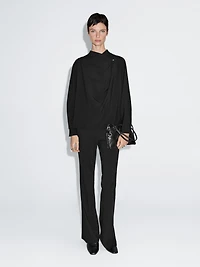 Blouse with crossover detail and button