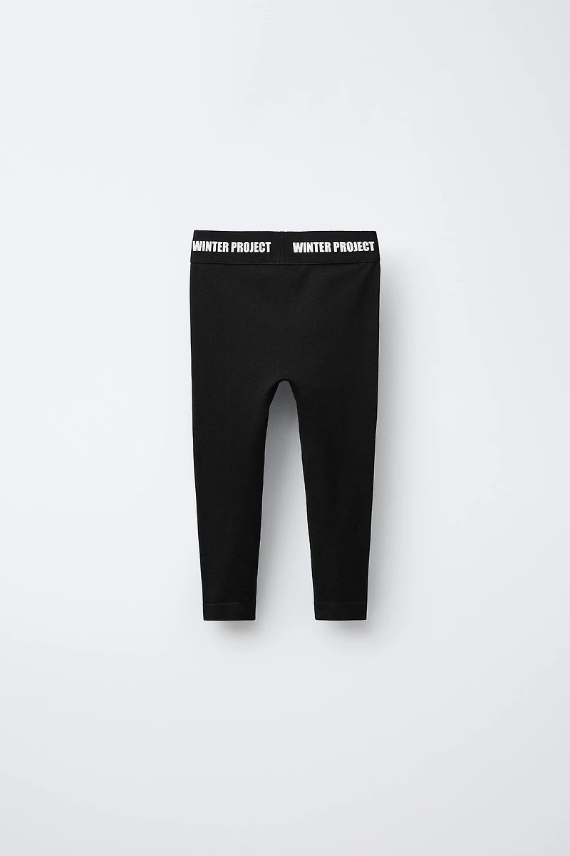 EMBOSSED TEXT RIBBED LEGGINGS