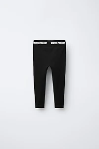 EMBOSSED TEXT RIBBED LEGGINGS