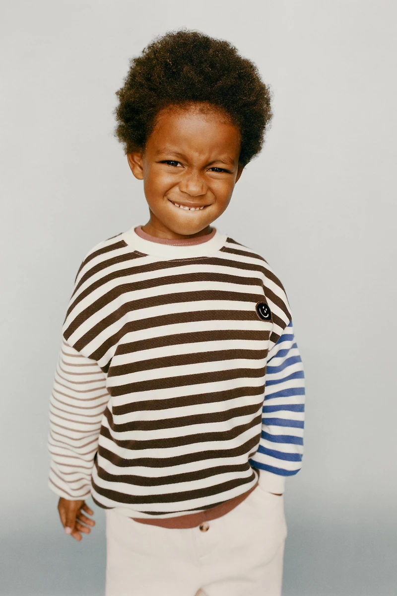 STRIPED SWEATSHIRT WITH FACE PATCH