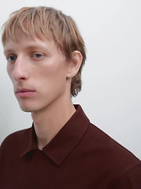 Textured polo shirt with hidden button