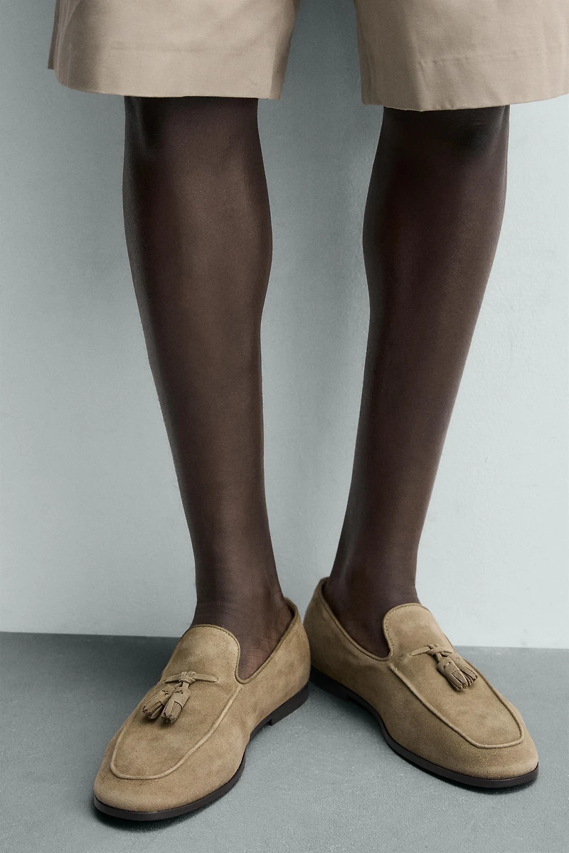 MOCASSINS EN CUIR À POMPONS