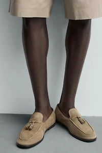 MOCASSINS EN CUIR À POMPONS
