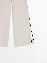 Linen trousers with contrast piping