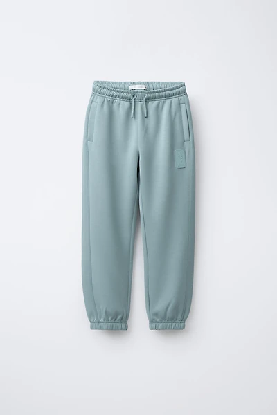 SPORTY JOGGER PANTS WITH RUBBERIZED LABEL