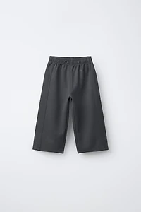 WIDE LEG INTERLOCK RAISED TEXT PANTS
