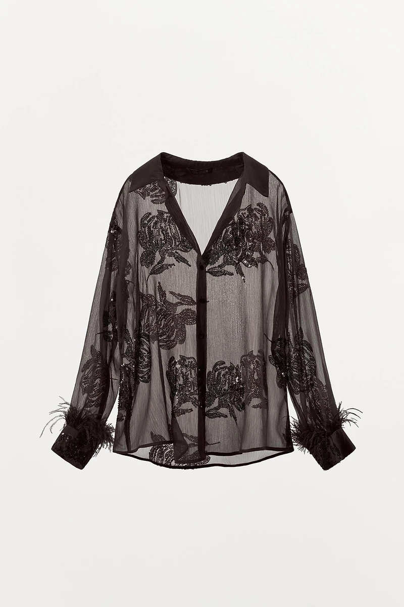 BLOUSE SEMI-TRANSPARENTE PAILLETTES PLUMES