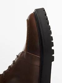 Lace-up leather boots with lined interior