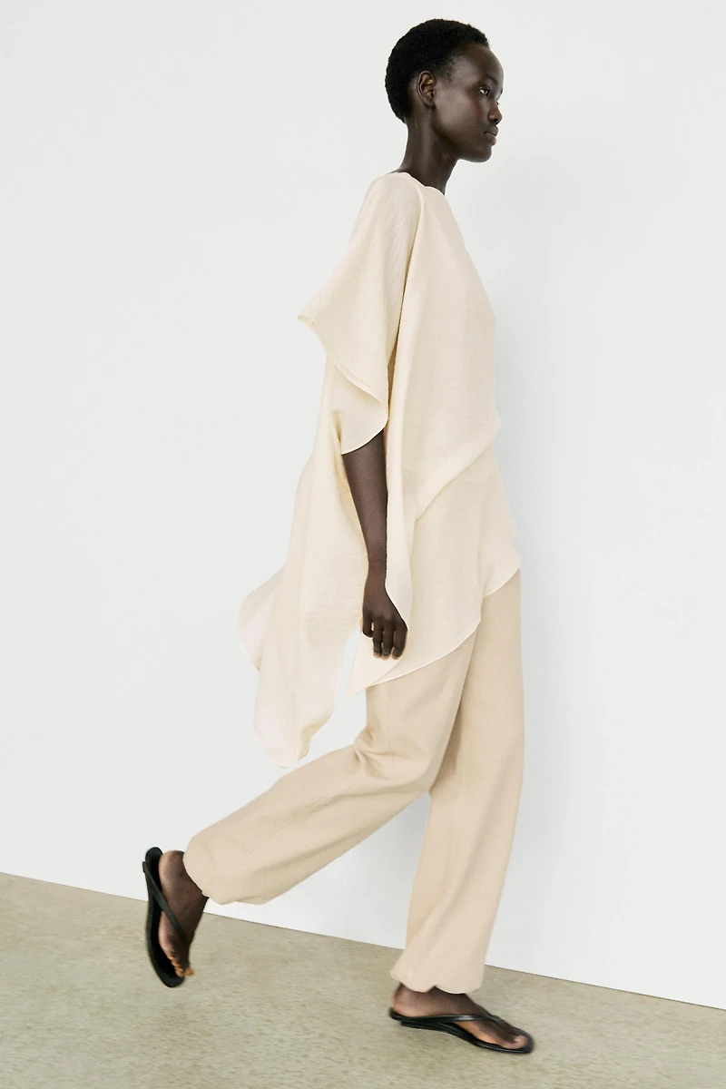 Asymmetric cape-style flowing blouse