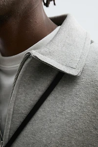 POLO EN MAILLE À COL ZIPPÉ