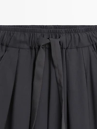 Voluminous wide-leg pleated trousers