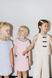 CONTRAST PIPING AND BOW DRESS