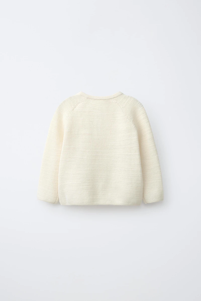 PULL EN MAILLE PERLÉE AVEC ÉTIQUETTE