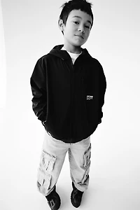 VESTE TECHNIQUE DOUBLÉE CAPUCHE DÉPERLANTE