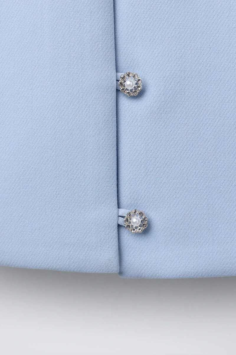 TOP AVEC BOUTON BIJOU