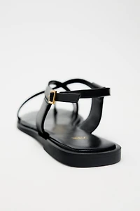 FLAT SANDALS WITH METALLIC DETAIL