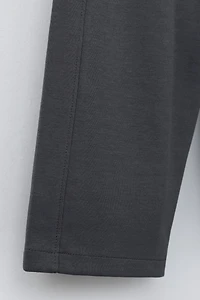 WIDE LEG INTERLOCK RAISED TEXT PANTS