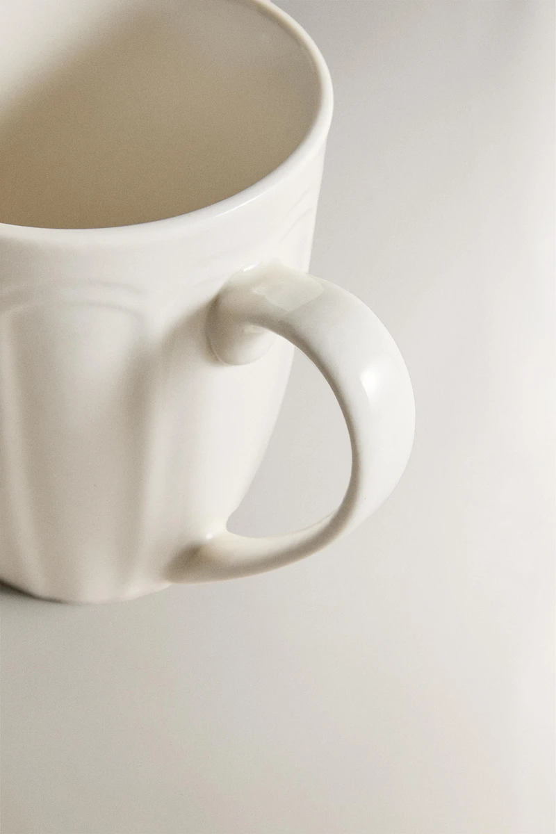 PORCELAIN MUG WITH RAISED DESIGN